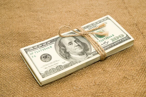 One pack of dollars on an old cloth — Stock Photo, Image