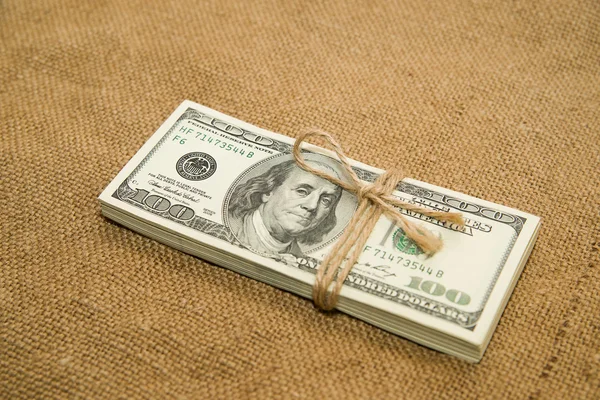 One pack of dollars on an old cloth — Stock Photo, Image