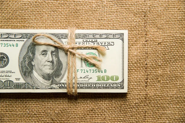 One pack of dollars on an old cloth — Stock Photo, Image