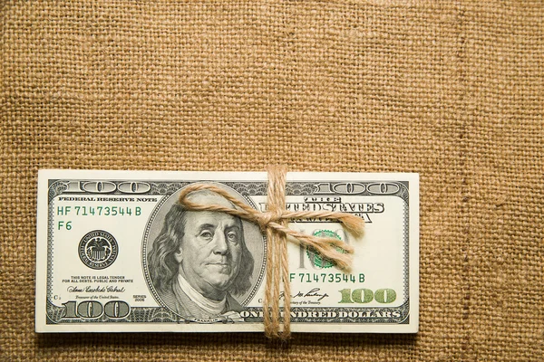 One pack of dollars on an old cloth — Stock Photo, Image