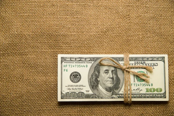 One pack of dollars on an old cloth — Stock Photo, Image