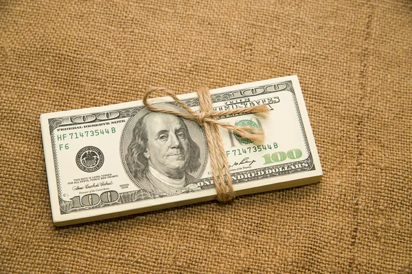 One pack of dollars on an old cloth — Stock Photo, Image