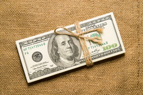 One pack of dollars on an old cloth — Stock Photo, Image