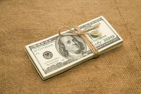 One pack of dollars on an old cloth — Stock Photo, Image