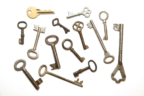 Many old keys to the safe on a white background — Stock Photo, Image