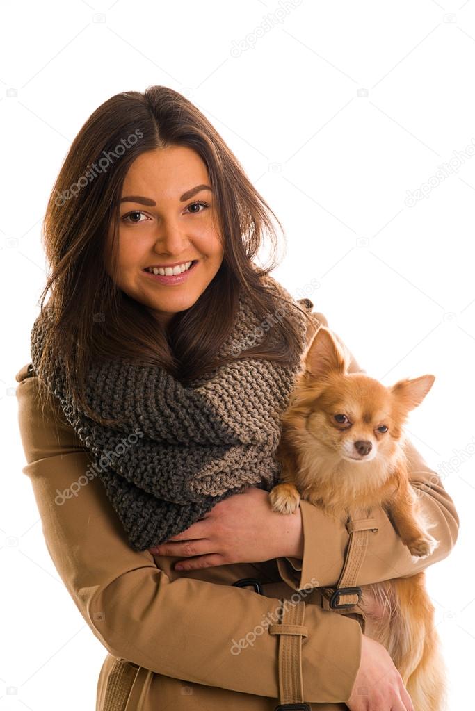 A girl in a grey knitted scarf smiling.
