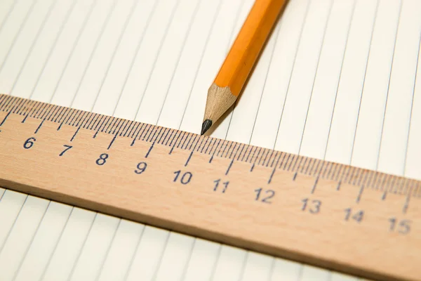 Notepads, pencil and wooden ruler on the old tissue — Stock Photo, Image