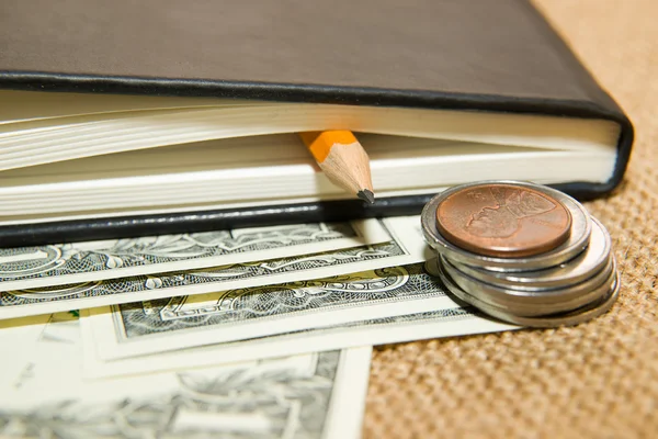 Notebook, pencil and money on the old tissue — Stock Photo, Image