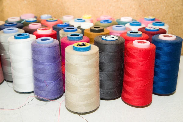 Many reels of  threads standing on the table — Stock Photo, Image