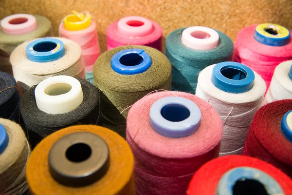 Many reels of  threads standing on the table — Stock Photo, Image