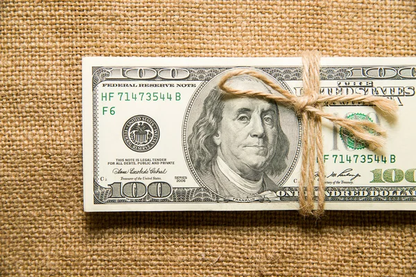 One pack of dollars on an old cloth — Stock Photo, Image