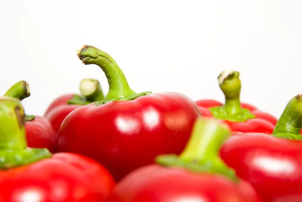 Many ripe red peppers on over white — Stock Photo, Image