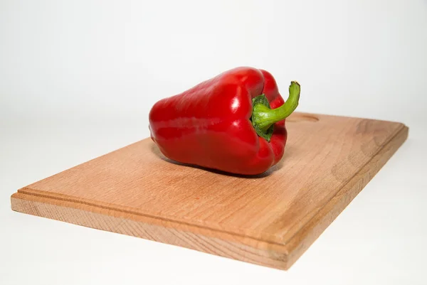 One ripe red peppers on over white — Stock Photo, Image