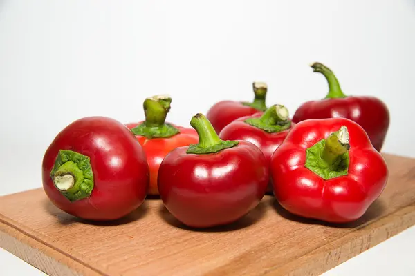 Many ripe red peppers on over white — Stock Photo, Image