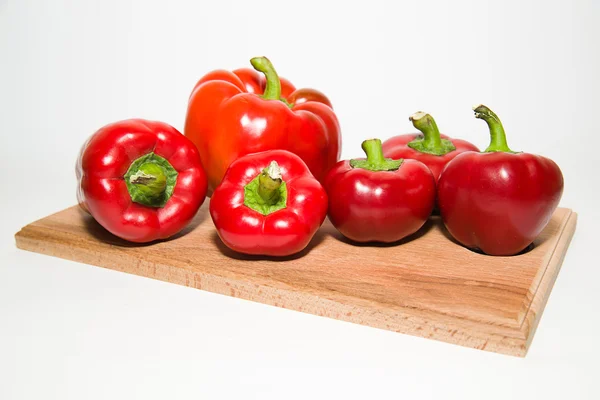 Many ripe red peppers on over white — Stock Photo, Image