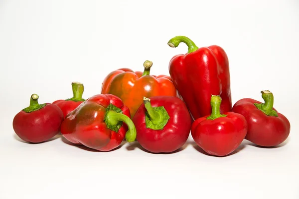 Many ripe red peppers on over white — Stock Photo, Image