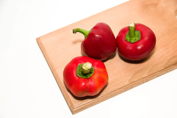 Three ripe red peppers on over white — Stock Photo, Image