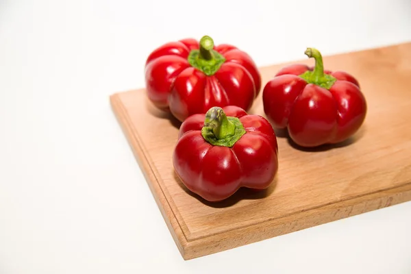 Three ripe red peppers on over white — Stock Photo, Image