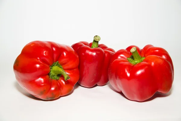 Three ripe red peppers on over white — Stock Photo, Image