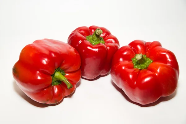 Three ripe red peppers on over white — Stock Photo, Image