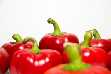 Birçok olgun kırmızı biber üzerinde beyaz üzerinde