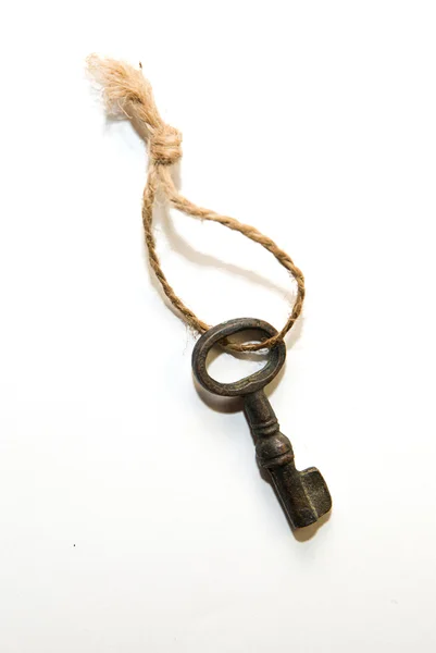 Vintage key on a rope on over white — Stock Photo, Image