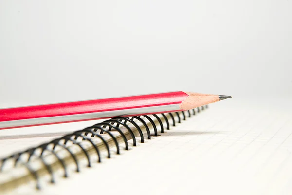 Caderno aberto e lápis sobre branco — Fotografia de Stock