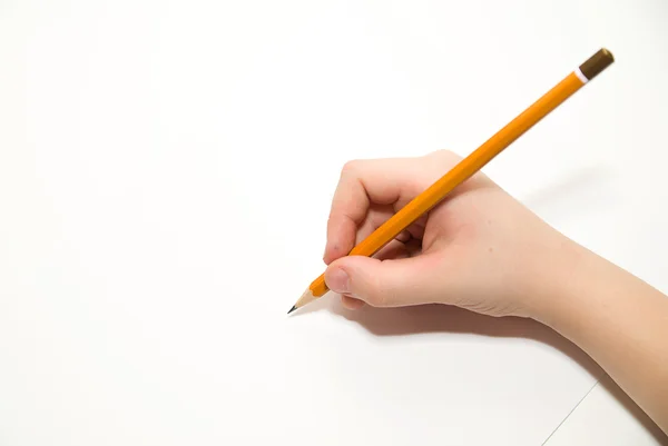 Kid's rigth hand holding a pencil on over white — Stock Photo, Image