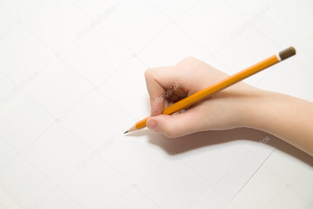 Kid's right hand holding a pencil on over white