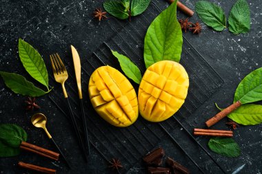 Taze sulu mango çatal bıçakla parçalara ayrılmış. Üst Manzara. Kırsal biçim.