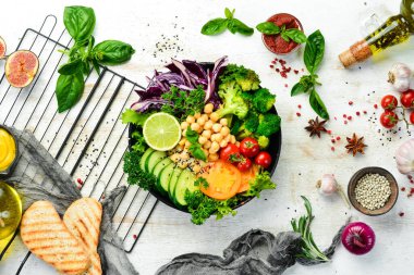 Vejetaryen Buda kasesi: Siyah taş tabakta nohut, brokoli, domates ve salatalık. Yiyecekler. Üst Manzara. Metnin için boş yer.