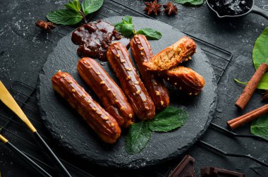 Karamelli kremalı pasta. Siyah taş tabakta karamel ve fındık tatlısı. Üst Manzara. Kırsal biçim.