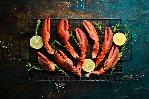 Lobster claws. Boiled crustacean claws on a black stone background. Rustic style.