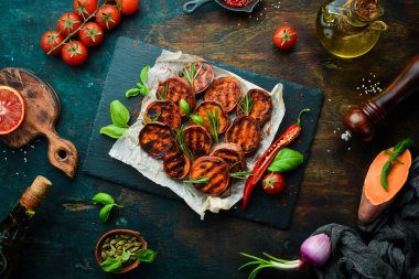 Kızarmış patates, biberiye, kırmızı biber ve siyah taş tabakta kırmızı biber. Üst Manzara. Metnin için boş yer.