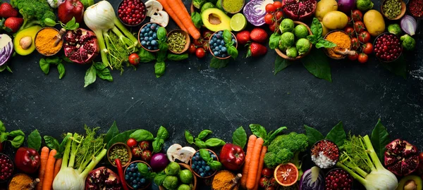 新鮮な野菜や果物 フェンネル アボカド ザクロ ベリー キャベツ バジル 有機健康ビーガンフード 黒石の背景に — ストック写真