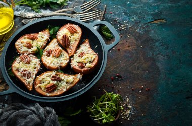 Fırında armut, mavi peynir ve fındık. Kızartma tavasında. Kırsal tarzda. Düz Yat.