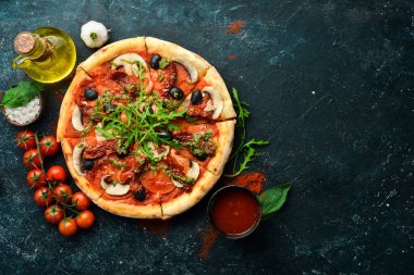 Güneşte kurutulmuş domatesli, mantarlı ve zeytinli ev yapımı pizza. İtalyan mutfağı. Yemek teslimatı.