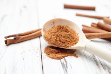 Tarçın tahta kaşık ve tarçın beyaz bac üzerinde