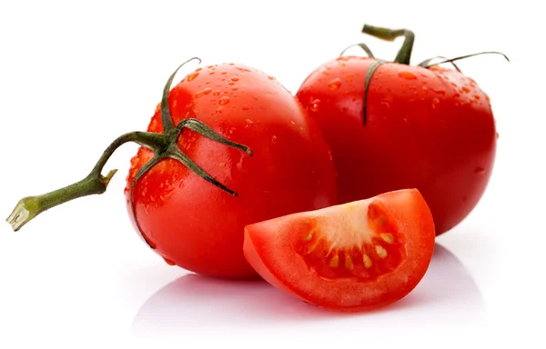 Two tomatoes and a part of it on a white background — Stock Photo, Image
