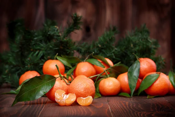 Tangerines avec feuilles sur la surface en bois — Photo