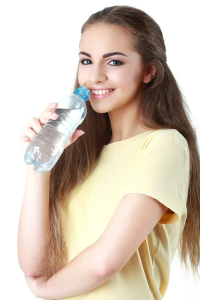 Fiatal nő az ivóvíz, a fehér háttér — Stock Fotó