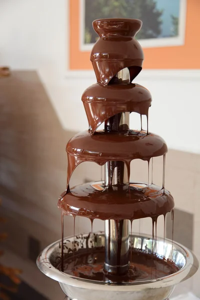 Chocolate fondue fountain with marshmallow being dipped. — Stock Photo, Image