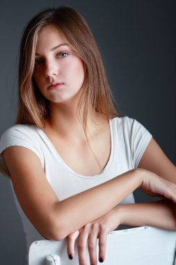 Güzel sarışın kadın sandalyede trendy bakışla