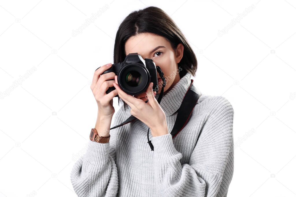 Woman photographer is taking images with dslr camera