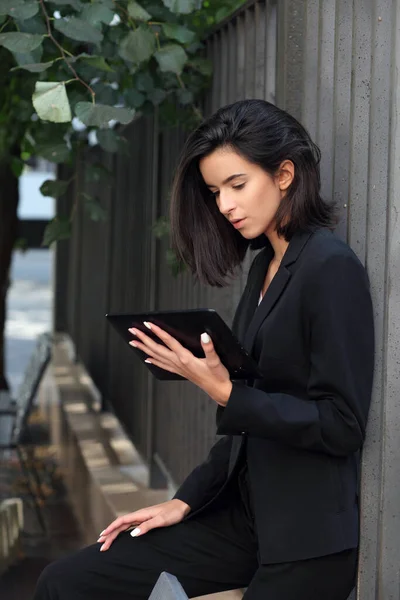 Business woman with tablet pc outdoor posing.