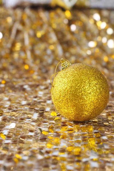 Golden christmas ball on glitter background