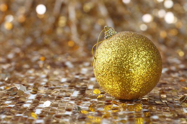 Golden christmas ball on glitter background