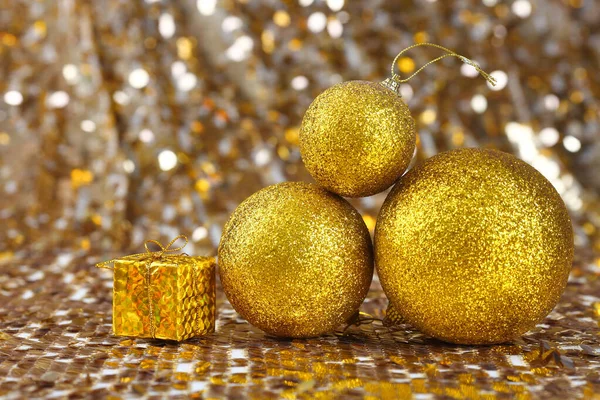 Golden christmas ball on glitter background