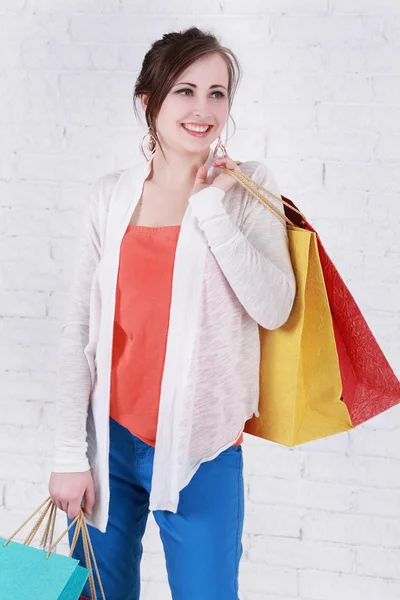 Portrait young girl with colored bags — Stock Photo, Image