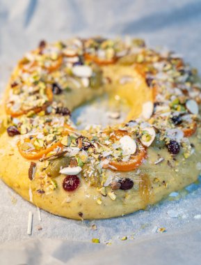 Roscon de Reyes geleneksel İspanyol tatlıları Noel 'de badem kreması ve kırsal arka planda şekerli meyvelerle yapılır.